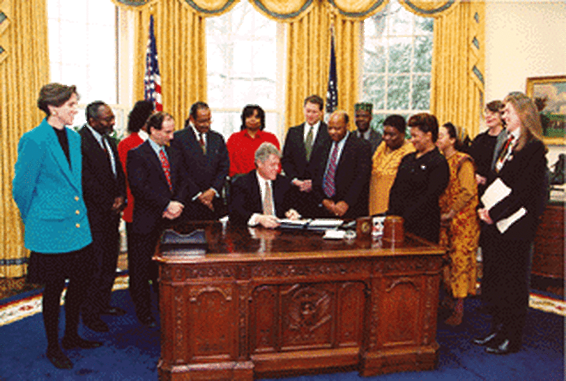 President Clinton signing document